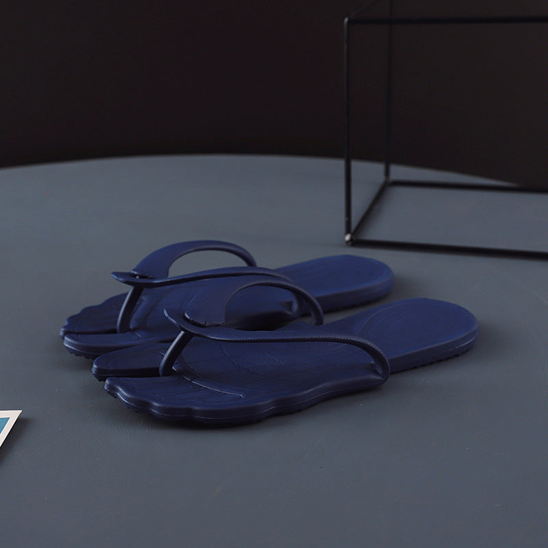 Light gray flip flops open flat showing the molded one piece EVA sole
