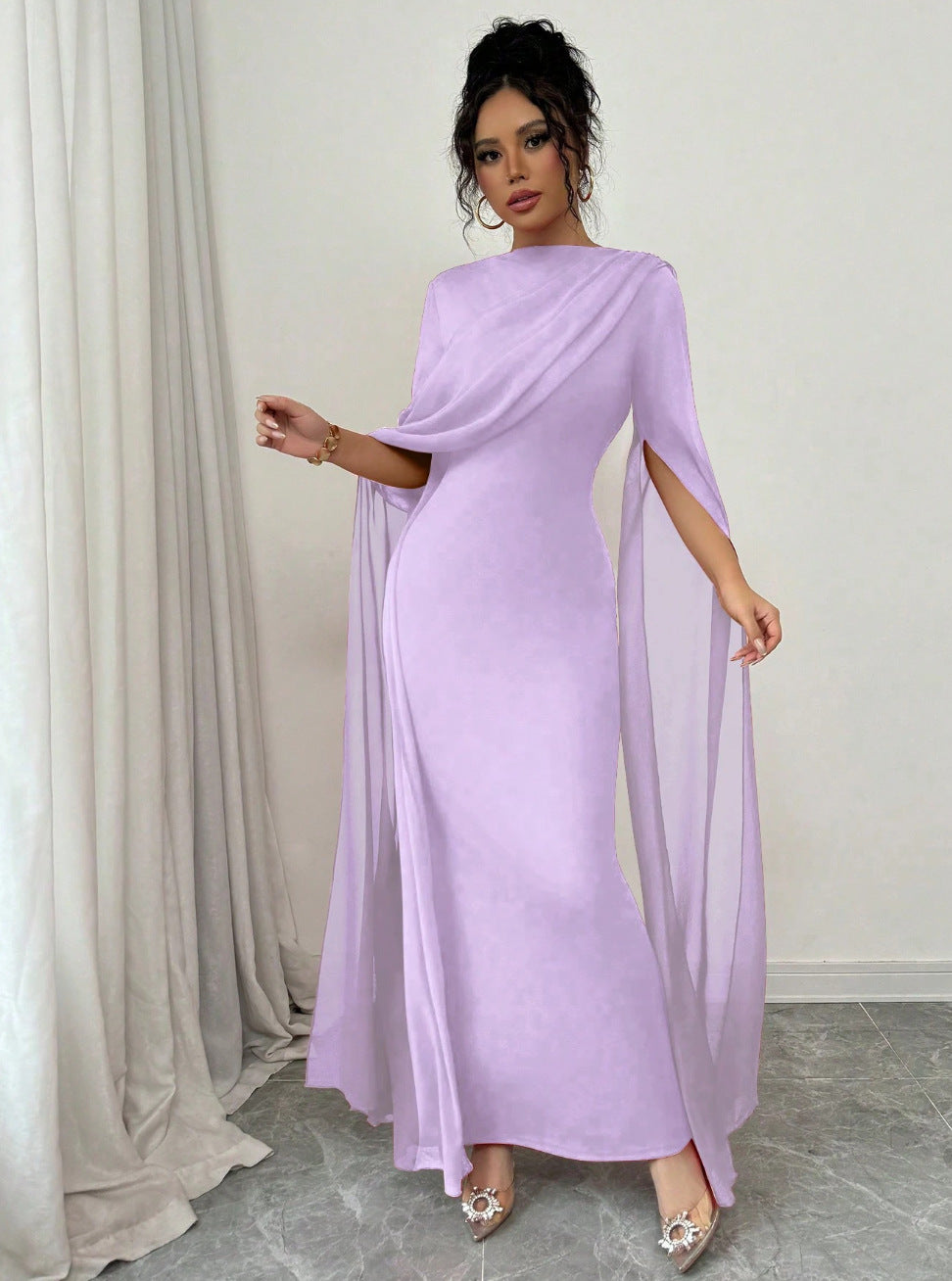 Lilac chiffon cape sleeve long gown with cinched waist and floor length skirt, on model