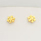 Top down layout of both mini snowflake floral gold stud earrings side by side