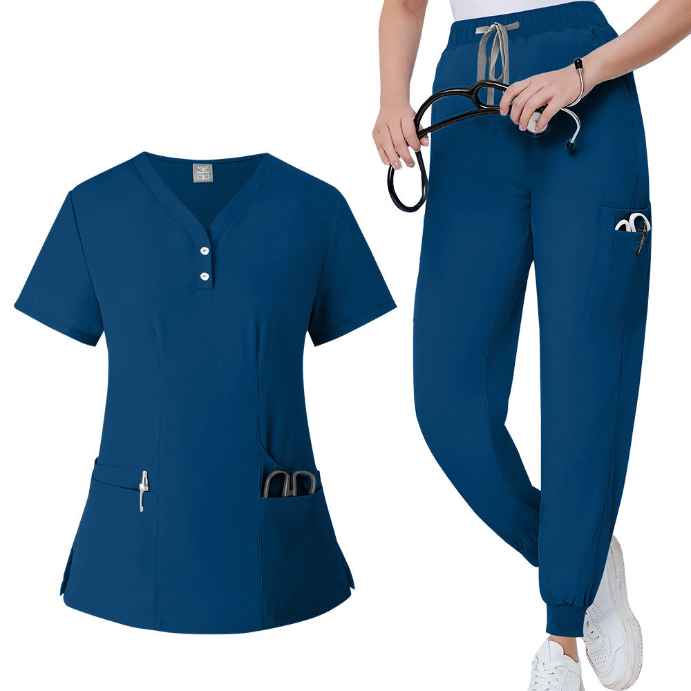 Womens V neck scrub top in navy blue worn from the front to show the fitted cut