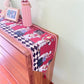Christmas table runner with cartoon chef pattern with checkerboard border on a sideboard, 33x220 cm option