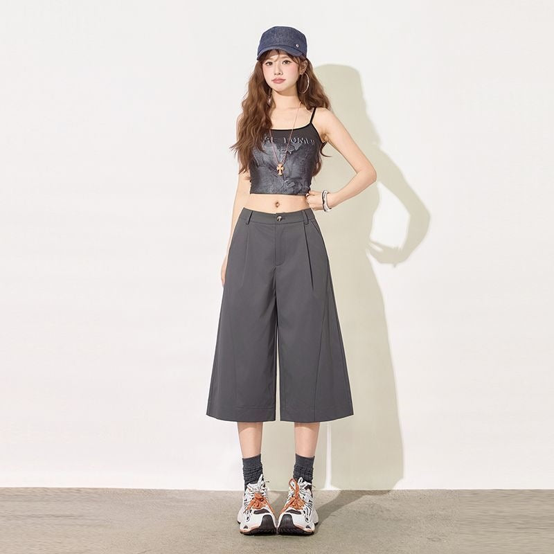 Dark gray tailored wide leg cropped pants showing pleated high waist
