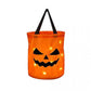 Orange LED pumpkin party bag with a carved jack o lantern face glowing and a black carry handle