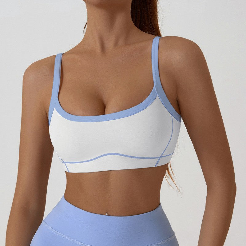 Two tone womens activewear set on a studio model with thin spaghetti straps crossing the back
