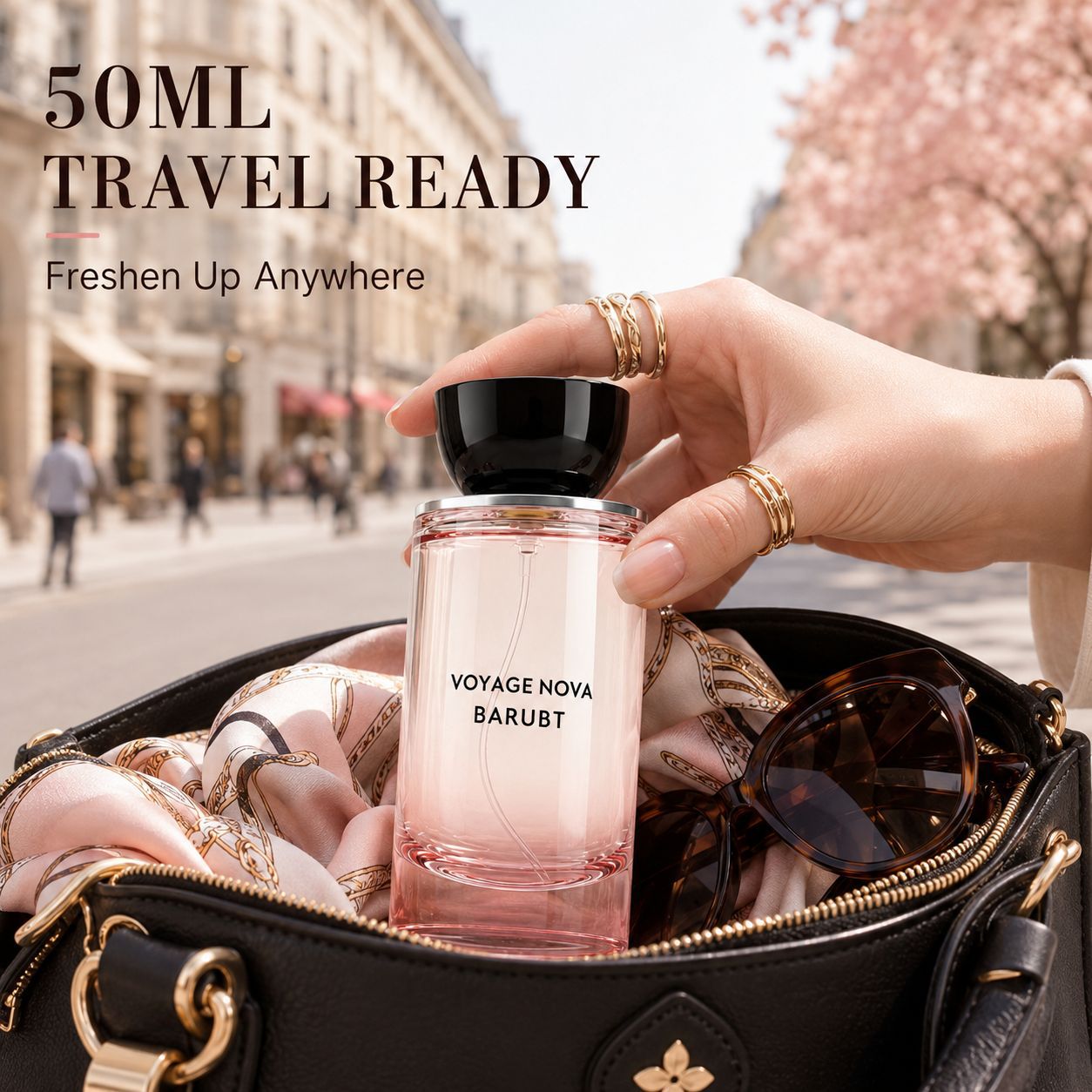 Hand lifting the black capped pink perfume bottle out of a black leather handbag on a city street