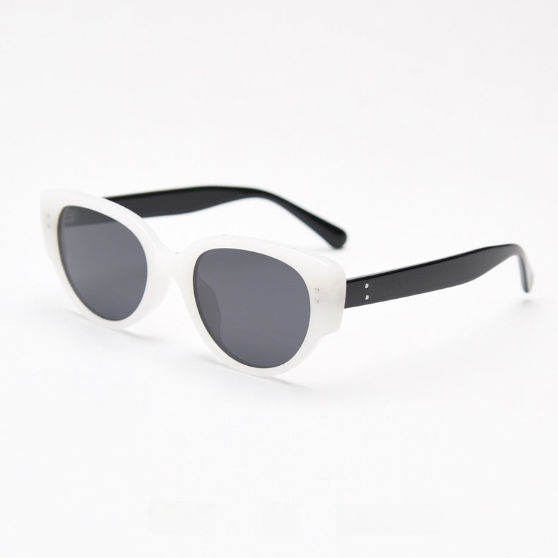 White frame with black temples and grey tinted polarized lenses at an angle