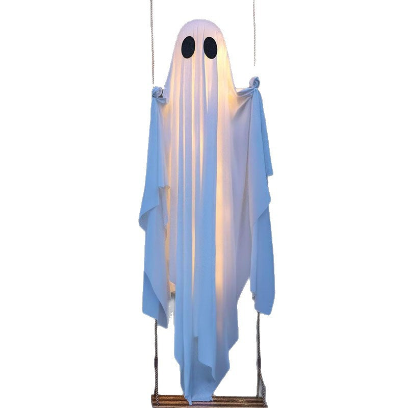 White cloth ghost decoration sitting on a rope swing with a wooden seat on a white background