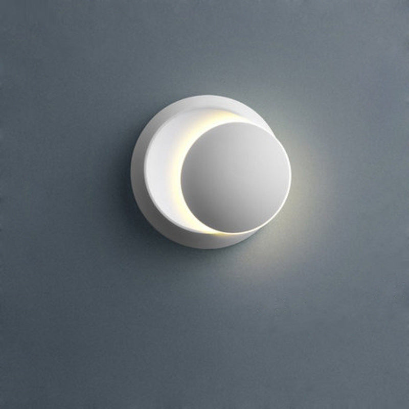 Crescent LED wall light in warm white mode close up