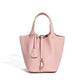Leather bucket tote bag hero shot on an off-white background