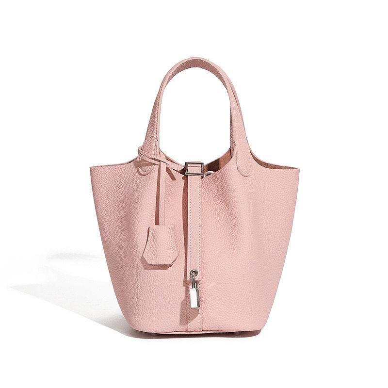 Leather bucket tote bag hero shot on an off-white background