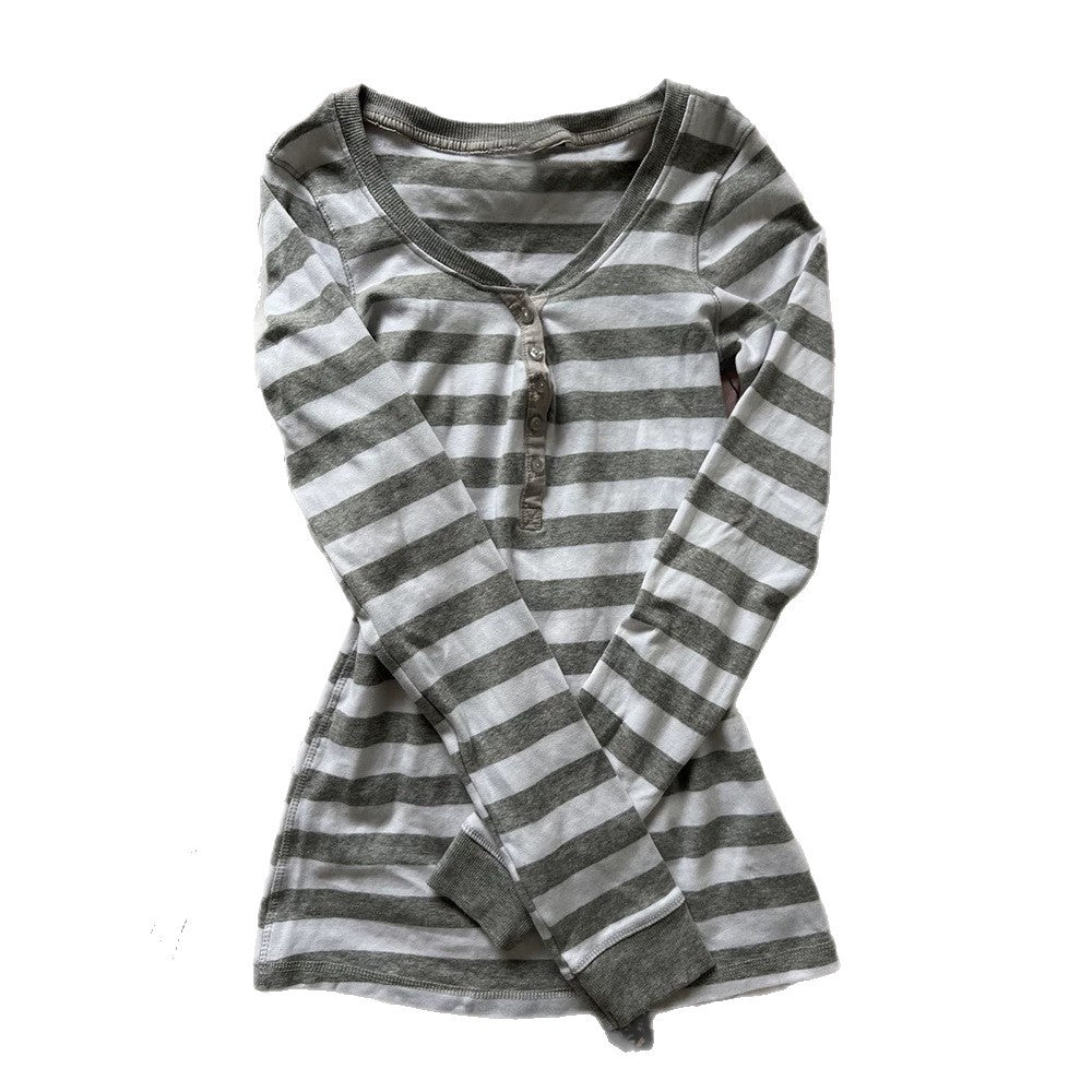 Gray and white striped long sleeve henley top laid flat on a white background with a four button placket