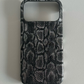Black and grey snake print half-cover phone case on a grey surface, Black Python, iPhone 18 Pro option