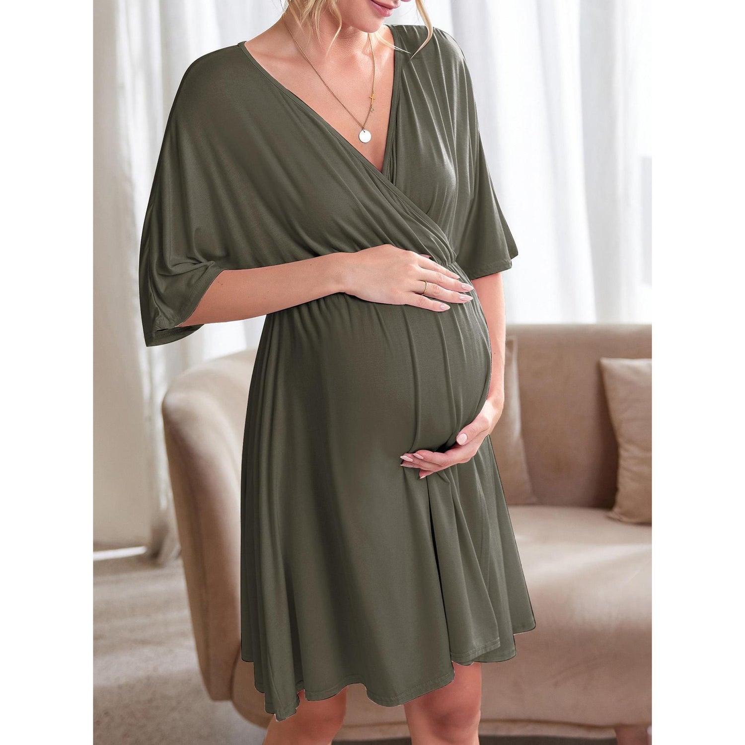 Maternity dress with gathered empire waist falling to a knee length A-line skirt