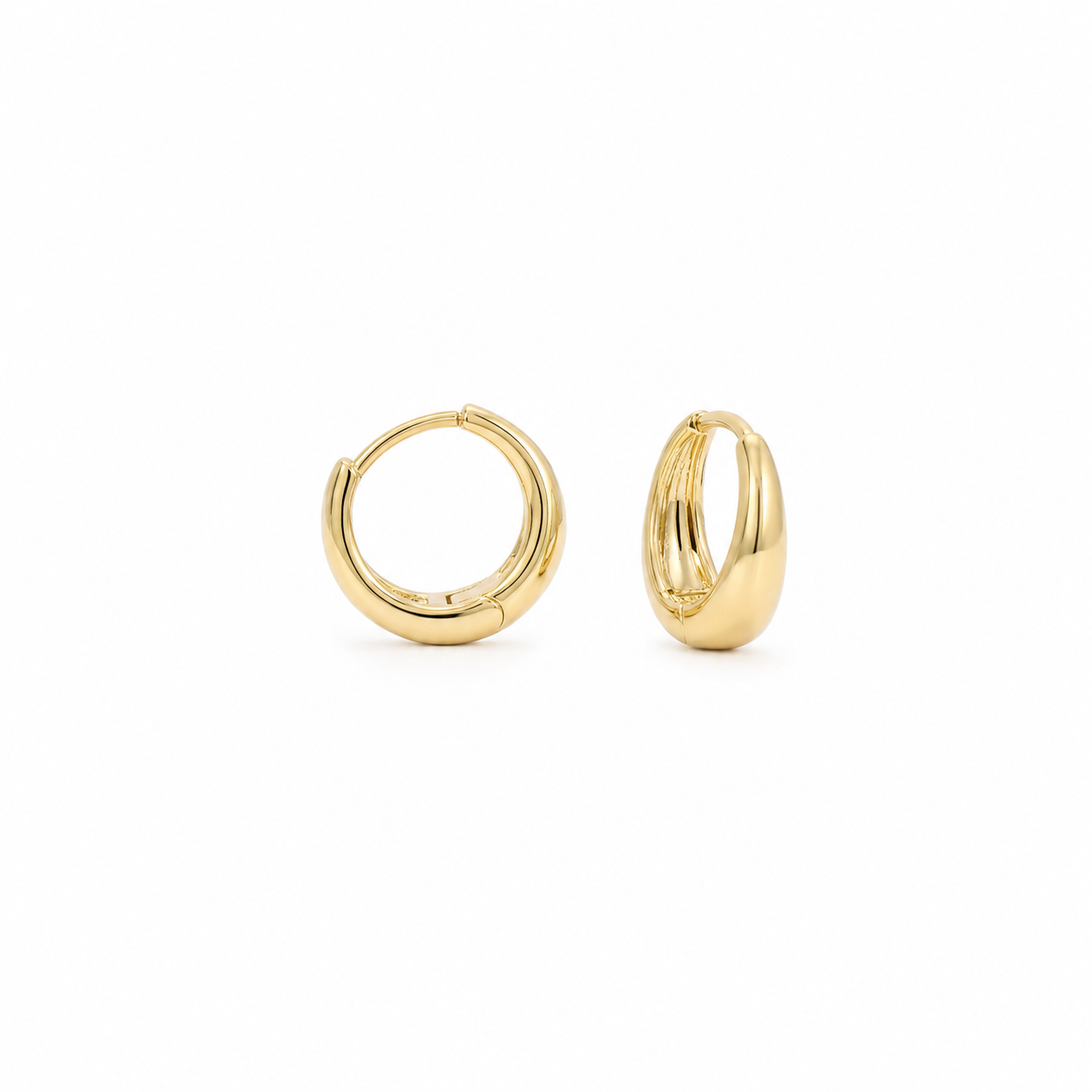 Pair of 18K gold plain hoops styled on a warm beige fabric backdrop