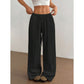 Close view of the elastic drawstring waistband on the wide leg cotton trousers