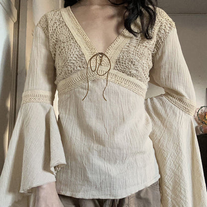 Close view of the cream crochet lace bodice, the V neckline and the suede look cord tied in a small bow