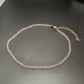 Brown faceted glass bead necklace with a gold tone extender chain