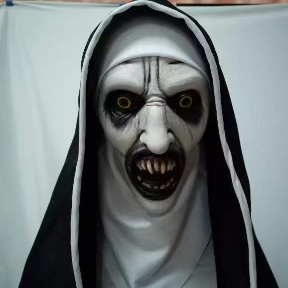 Horror nun latex costume mask displayed against a plain studio backdrop