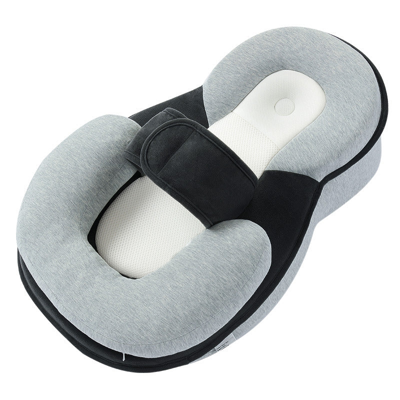 Grey wedge lounger pillow with a black panel, white mesh insert, curved head bolster and strap on a white background