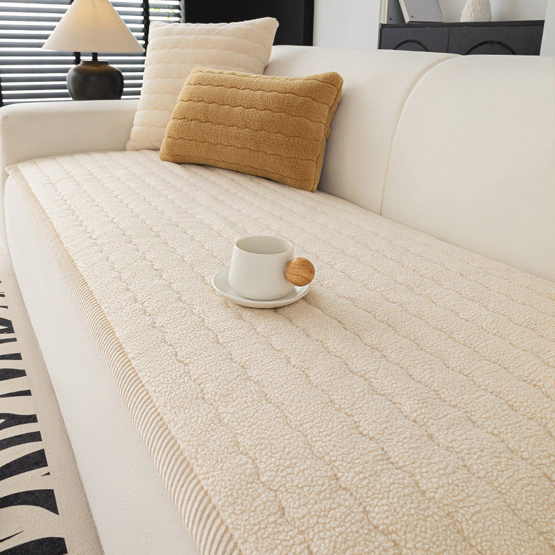 Quilted lambswool sofa cover with a wave stitch face on a sofa