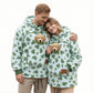 Couple in matching mint green heart print fleece hoodies with a puppy looking out of each chest pouch
