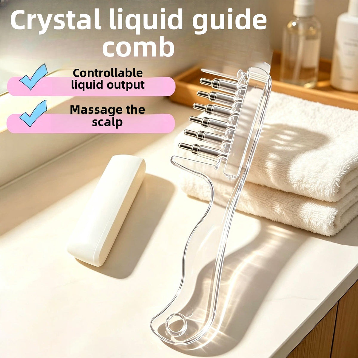 Clear liquid guide comb with metal ball tipped teeth lying on a bathroom counter next to a white towel