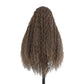 Back view of a long curly brown synthetic wig with light highlights on a white background