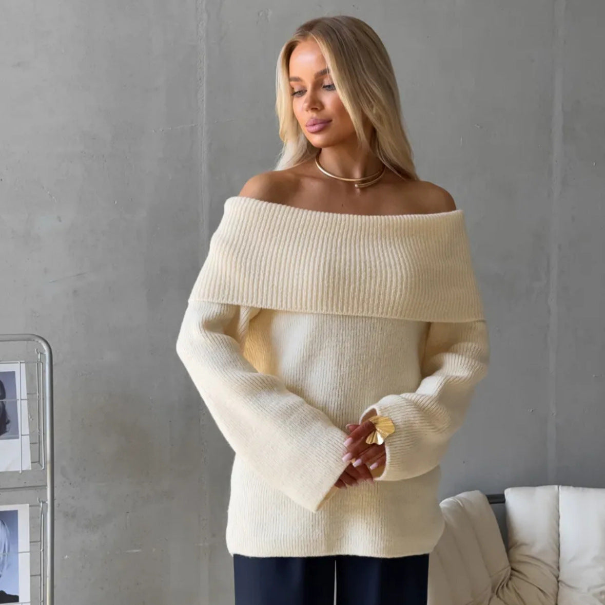 Cream white off-shoulder fold-over knit sweater with wide cuffs, front view on a model