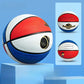 Red white and blue paneled kids basketball with a small size inset on a studio block