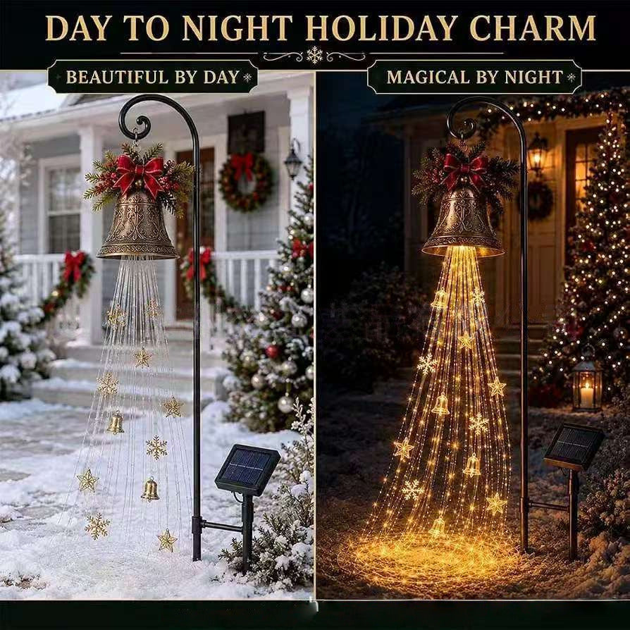 Christmas bell yard light by day on a snowy porch and lit at night with warm cascading strands and a solar panel stake