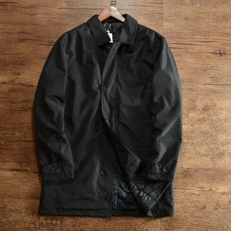 Black mid-length quilted lined coat with lapel collar and button cuff tab on a hanger, size XS option