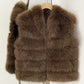Brown tiered vegan fur sleeveless vest in size L, front view on a wooden hanger