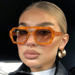 Side profile of polygonal sunglasses showing molded temple and double bridge
