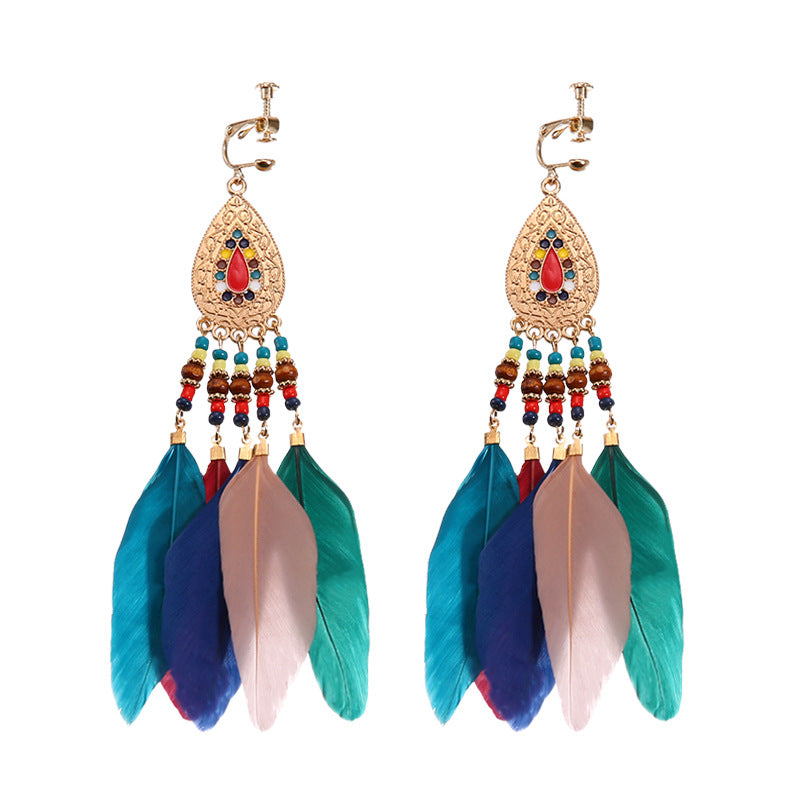 Bohemian tassel and bead clip-on drop earrings, aged tone zinc alloy frame, handmade pair on plain white background