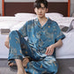 Man wearing pajama set relaxing on living room sofa