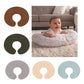 Five solid pillowcase colors, brown, dark olive, gray, peach and blue, beside a baby lying on a pillow near a sofa