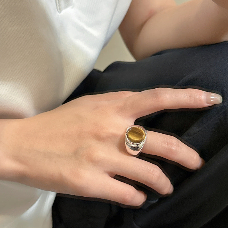 Chunky silver tiger eye ring worn on a hand