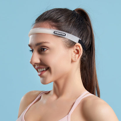 White silicone sports sweatband worn across the forehead of a smiling woman