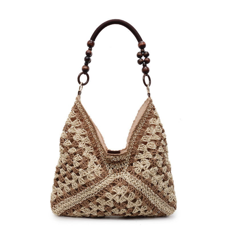 Natural beige open-weave hobo bag with wooden bead handle and lined interior on a white studio background