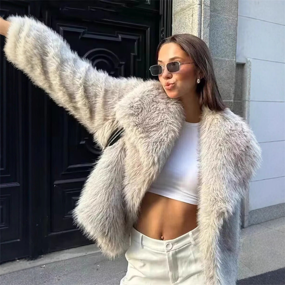 Faux fur jacket with an oversized shawl collar framing the neck over a plush fur body