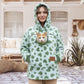 Woman in a mint green heart print fleece hoodie with a cat in the chest pouch, patio, size S option