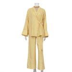Tie-front top and high-waisted trousers set in yellow, front view on a plain background