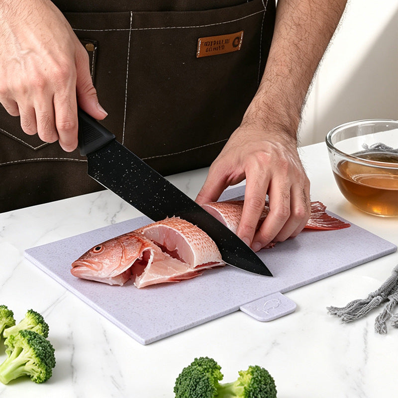 Color coded cutting board lifted from the upright storage stand on a counter