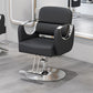 Black salon styling chair with curved gold metal armrests on a gold disc base in a salon