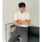 Green knitted short sleeve polo with an open lapel collar on a model