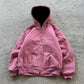 Pink washed hooded zip jacket with large front pockets and a ribbed hem on a concrete floor