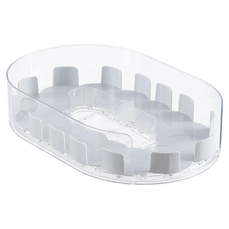 Clear oval rotating storage tray with gray white dividers on a white background, shown empty from above