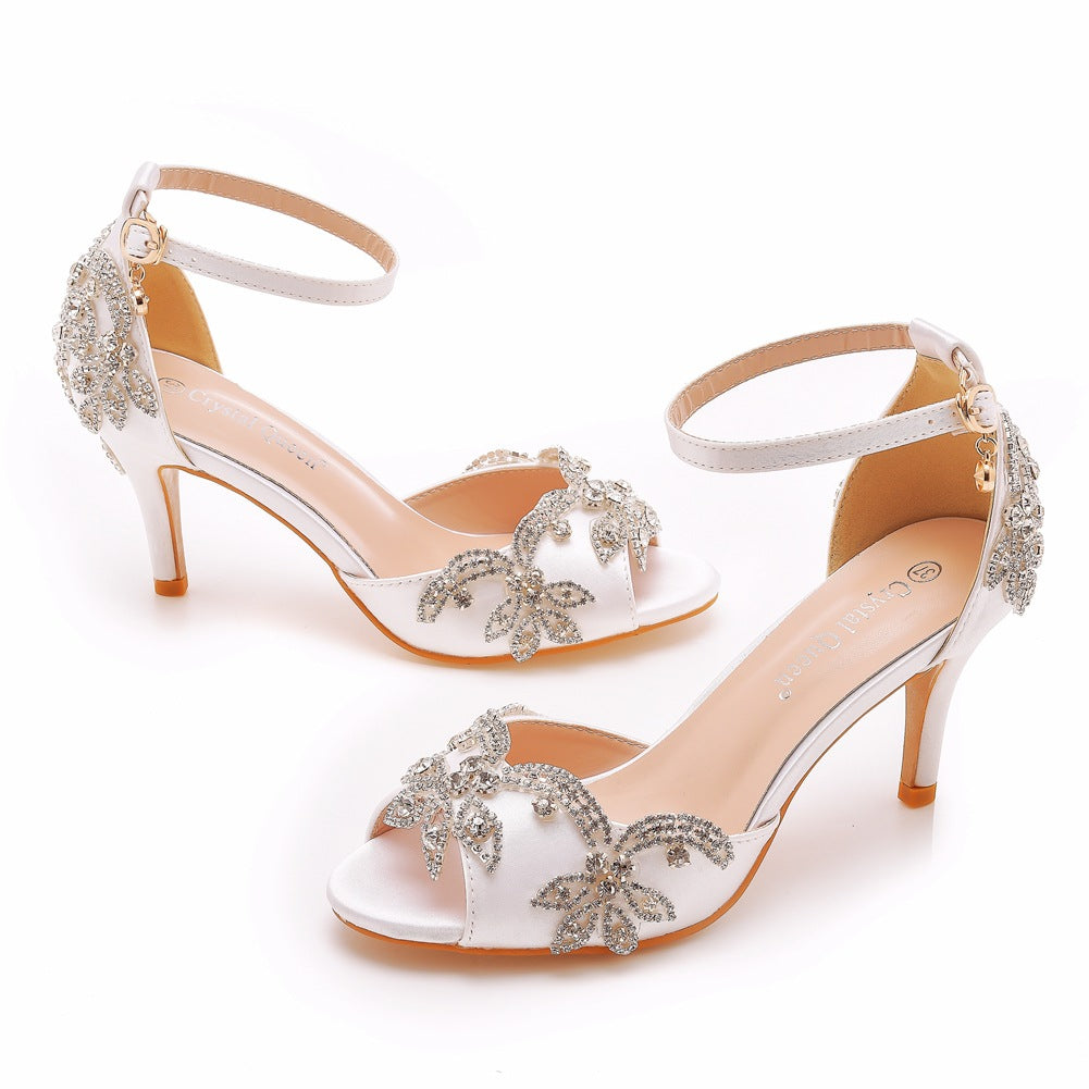 Rhinestone evening sandal photographed against a plain background, open toe forward