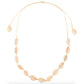 Cowrie shell choker on cream cord laid flat, sliding knot at the top and a shell on each tail