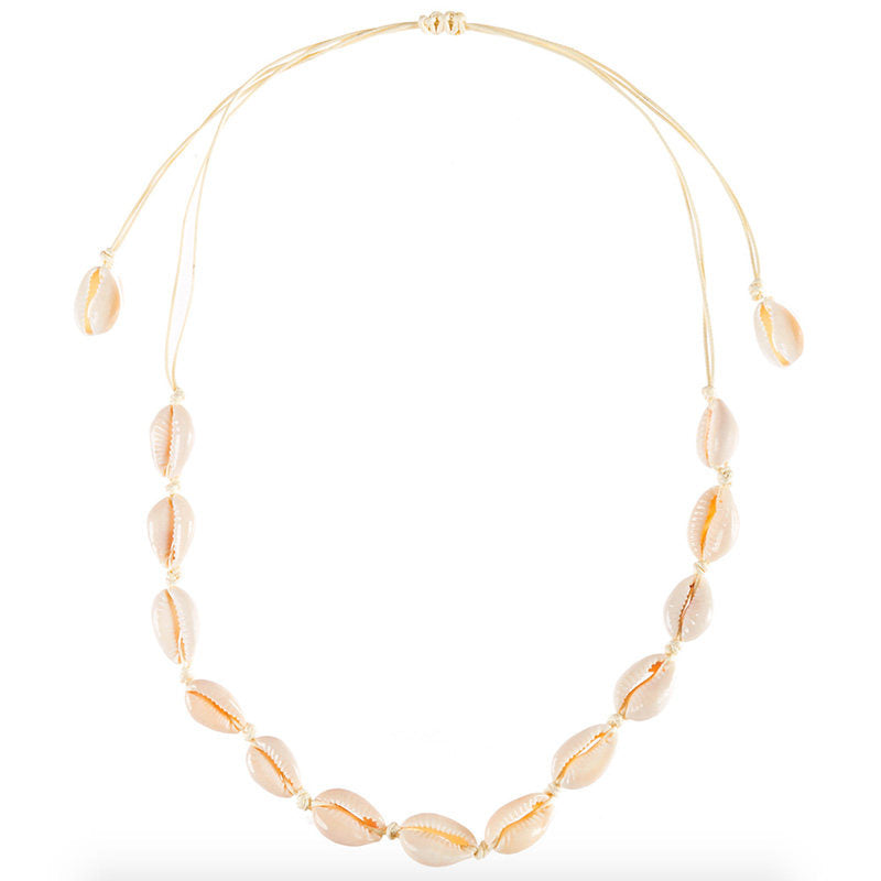 Cowrie shell choker on cream cord laid flat, sliding knot at the top and a shell on each tail